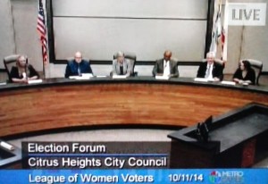 The five city council candidates seated next to a League of Women Voters moderator at Saturday's forum.