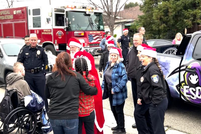 Along with Santa and Mrs. Clause, police officers and firefighters delivered piles of wrapped gifts to children for the holidays.