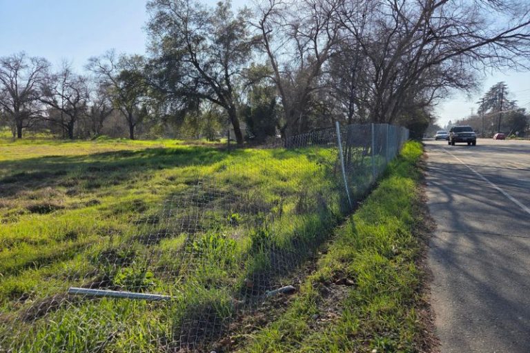A vacant lot on Old Auburn Road across from Holy Family Catholic Church is for sale. // CH Sentinel