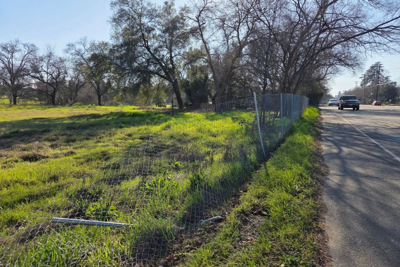 A vacant lot on Old Auburn Road across from Holy Family Catholic Church is for sale. // CH Sentinel