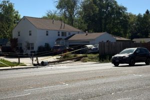 Photos show a vehicle with back-end damage appearing to have crashed into the garage of a residence, with the power pole and electricity lines having fallen across the driveway of the impacted residence. // CH Sentinel