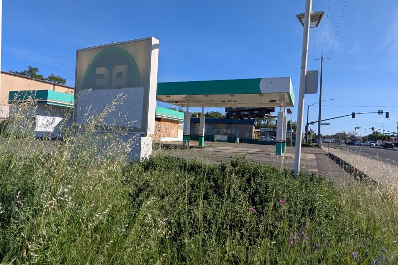 An old gas station on Auburn near Antelope sits vacant and boarded up, despite being purchased almost a year ago. // SB Williams