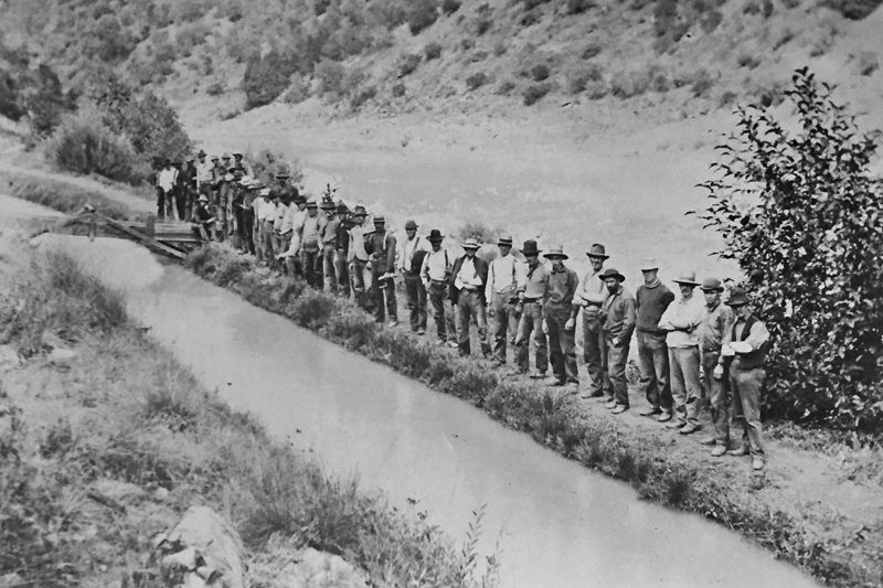 Workers for the North Fork Ditch Company line up by the North Fork Ditch that ran alongside the North Fork of the American River. The NFD received water from a diversion dam near the town of Auburn and brought it down to Baldwin Reservoir, located by the Northeast corner of Orangevale. The water served gold miners in the 1800s and farmers and ranchers in the first have of the 1900s. The Orangevale, Fair Oaks and Citrus Heights Irrigation Districts all received water from this ditch. Its’ use was discontinued with the construction of Folsom Dam. // Citrus Heights Historical Society