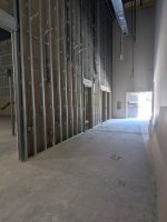 Before halting construction in 2019-2020, Studio Movie Grill built several rows of theater auditoriums throughout the 60,000-square-foot building. Some of the entrances framed out can be seen here. // SB Williams