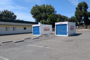 Two shipping/moving containers sit in the empty lot of a former preschool purchased by the city, which was intended to be utilized by a low cost spay feline. and neuter clinic. // SB Williams