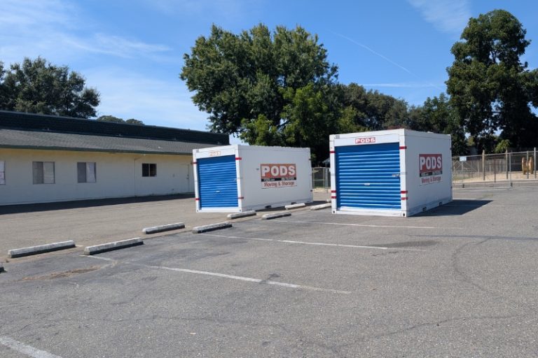 Two shipping/moving containers sit in the empty lot of a former preschool purchased by the city, which was intended to be utilized by a low cost spay feline. and neuter clinic. // SB Williams