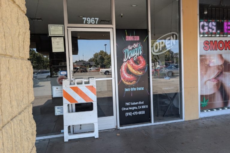 A donut shop on Auburn Blvd. has had "coming soon" signage on its windows for almost a year. // SB Williams
