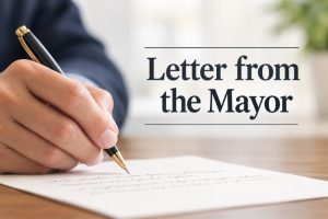 Letter from the Mayor Someone writing on paper with a pen