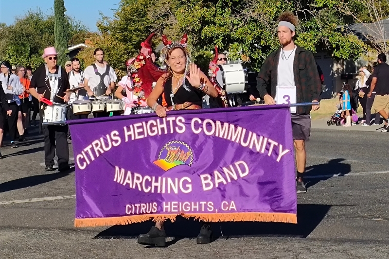 The Citrus Heights Community Marching Band holds its banner during the 2025 Howl O Ween parade on Grand Oaks Blvd., Oct 2025. // SB Williams
